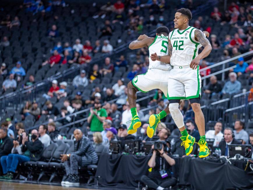 Oregon Ducks guard De'Vion Harmon (5) and teammate guard Jacob Young (42) celebrate a run to d ...