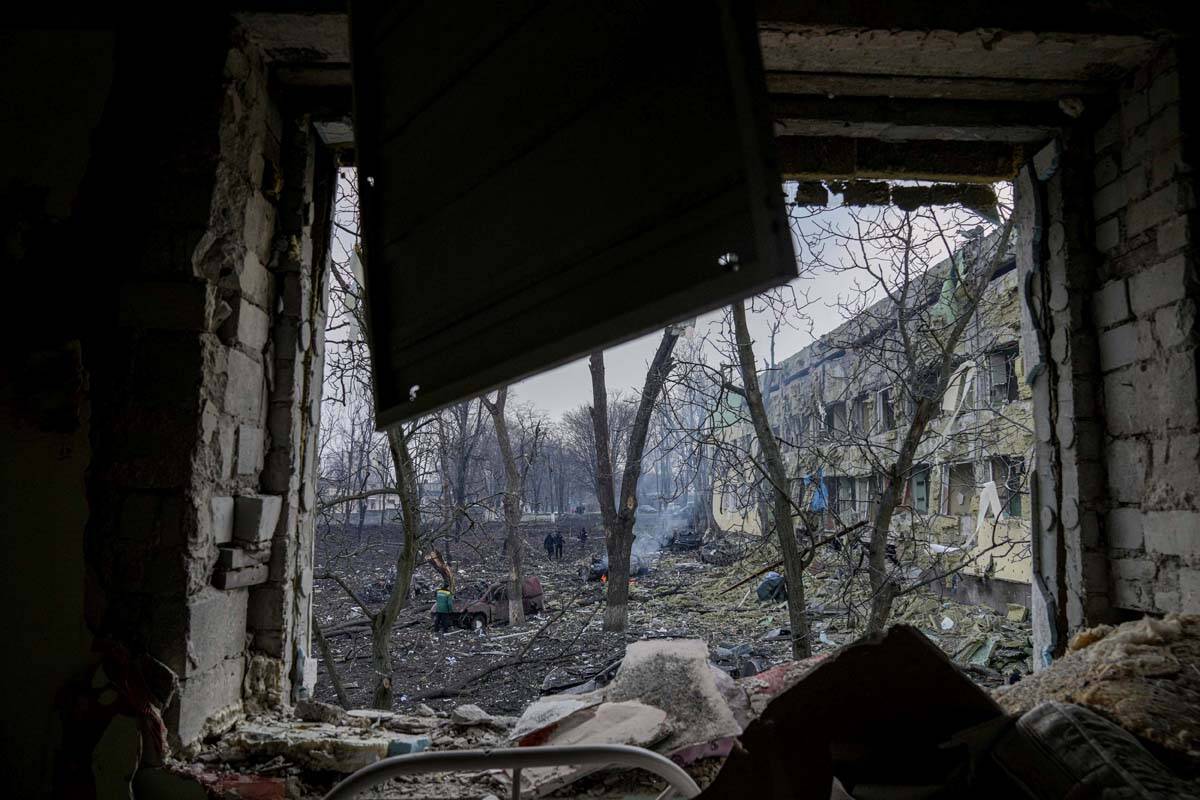 Ukrainian emergency employees work at the side of the damaged by shelling maternity hospital in ...