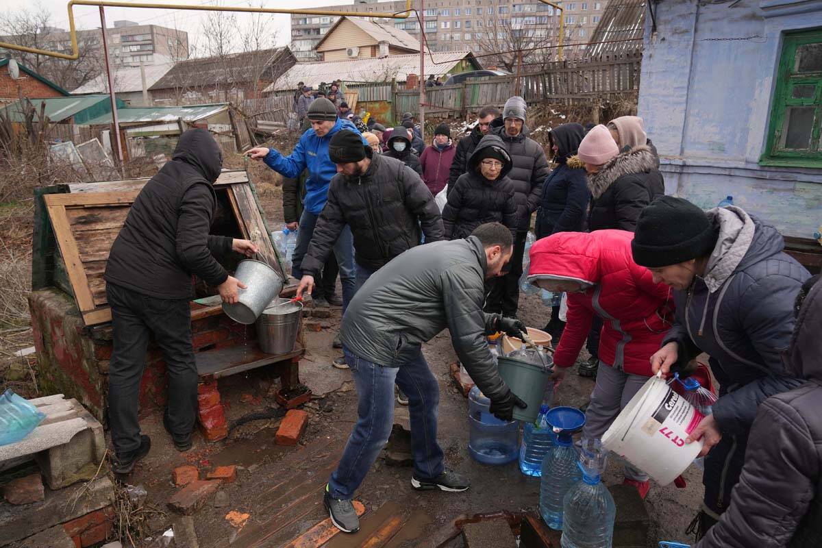 People line up to get water at the well in outskirts of Mariupol, Ukraine, Wednesday, March 9, ...