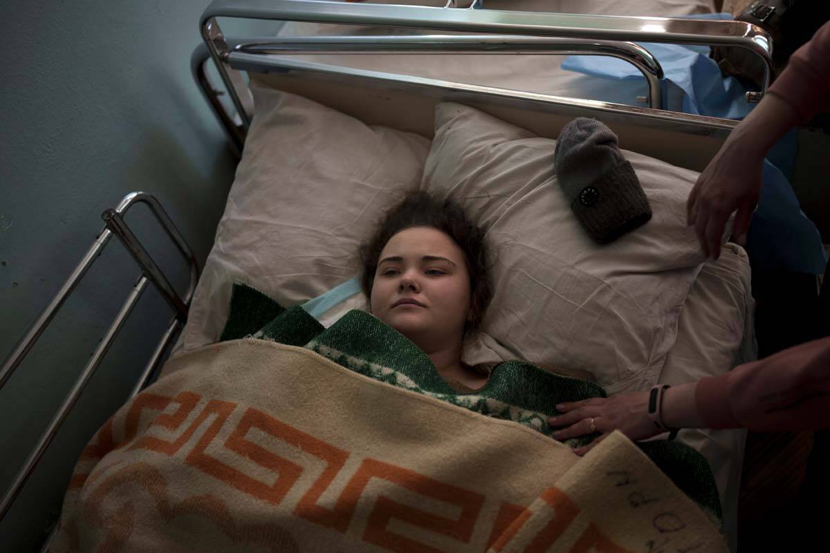 Katya, 14-years-old, is treated in a hospital after being shot while fleeing with her family fr ...