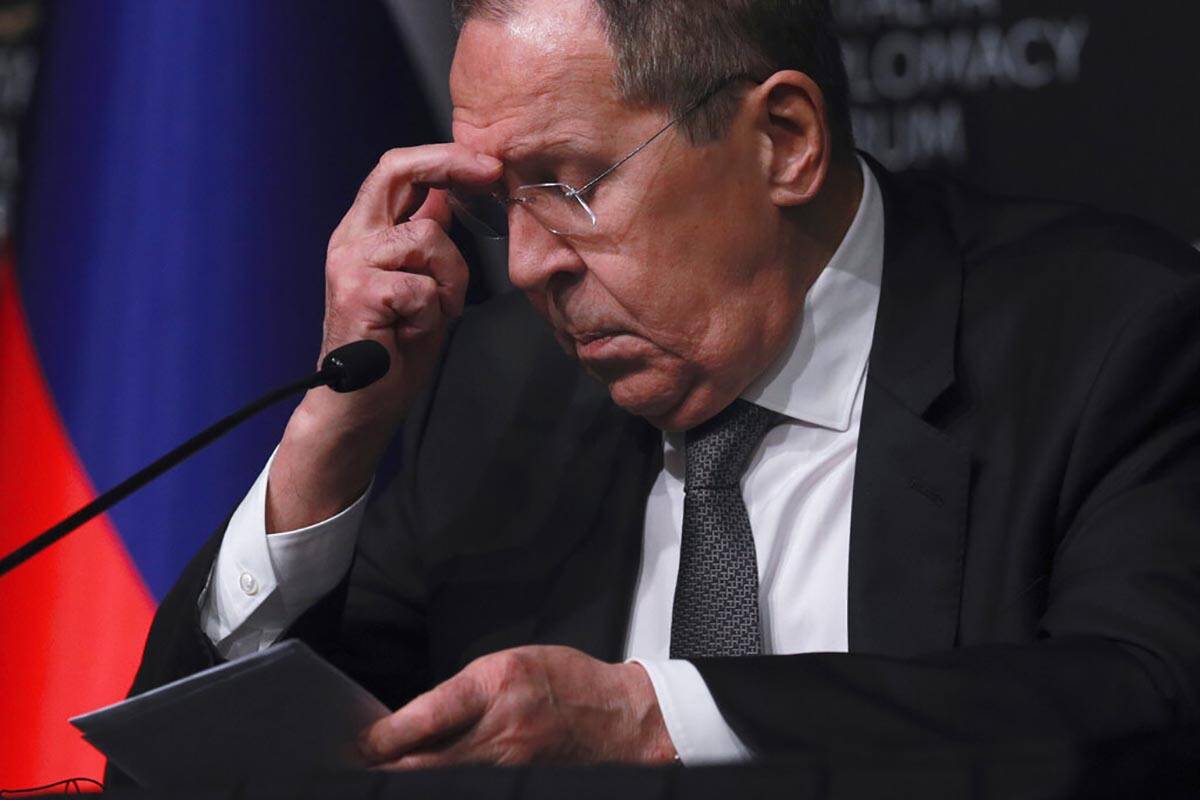 Russia's Foreign Minister Sergey Lavrov listens to questions during a news conference following ...