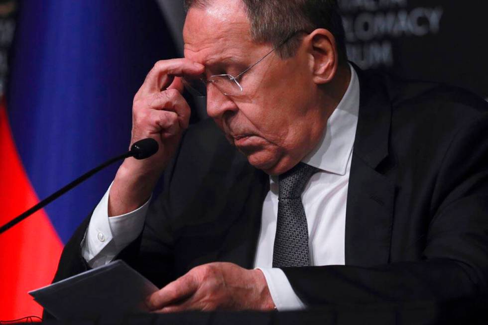 Russia's Foreign Minister Sergey Lavrov listens to questions during a news conference following ...