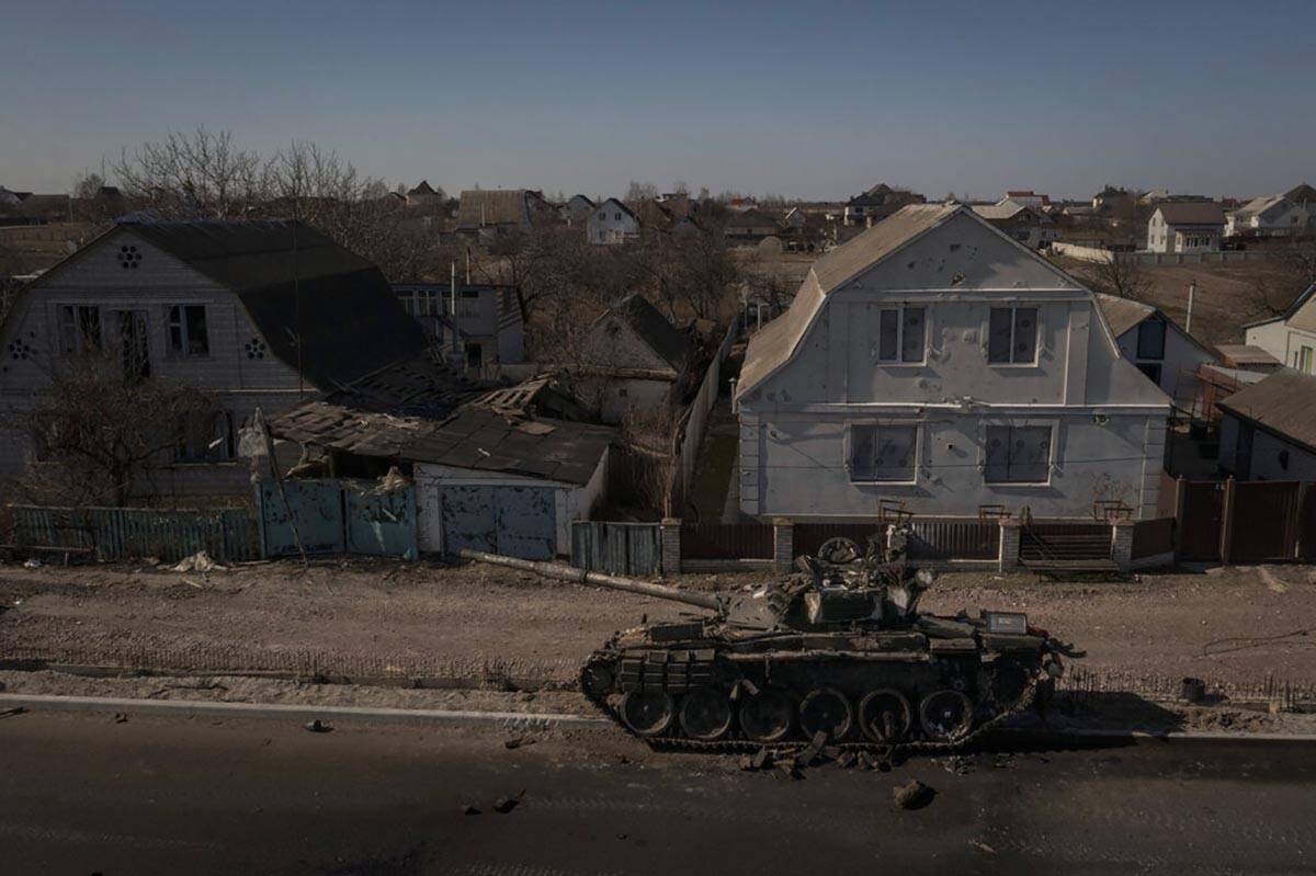 A destroyed tank is seen after battles between Ukrainian and Russian forces on a main road near ...
