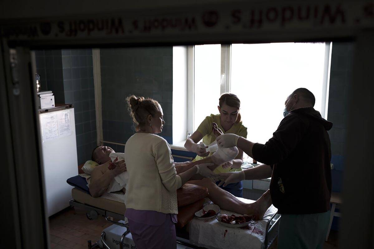 A man who injured by shelling near his home is treated at a hospital in Brovary, north of Kyiv, ...