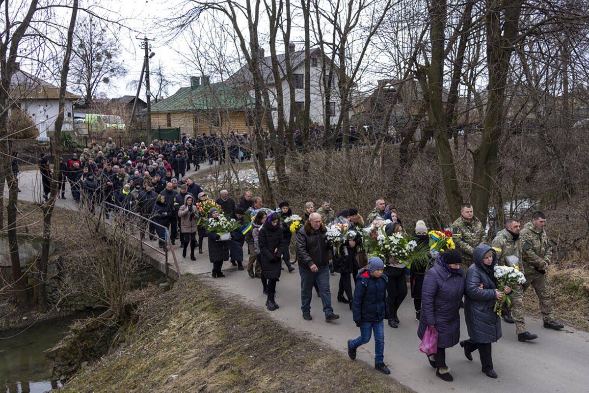 Relatives and friends attend the funeral of senior police sergeant Roman Rushchyshyn in the vil ...