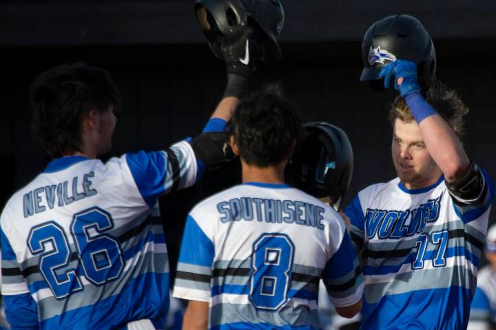 Basic’s Chase Ditmar (77) celebrates with Mason Neville (26) and Tate Southisene (8) aft ...