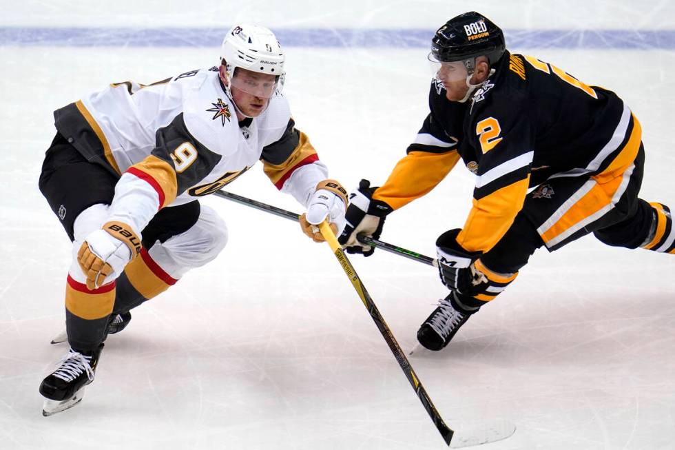 Vegas Golden Knights' Jack Eichel (9) gets around Pittsburgh Penguins' Chad Ruhwedel during the ...