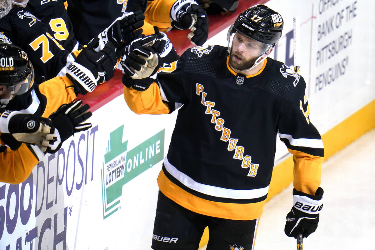 Pittsburgh Penguins' Bryan Rust (17) returns to the bench after scoring during the third period ...