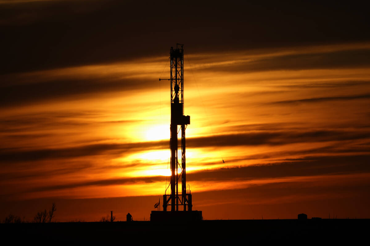 An oil drilling rig is pictured at sunset, March 7, 2022, in El Reno, Okla. Social media users ...