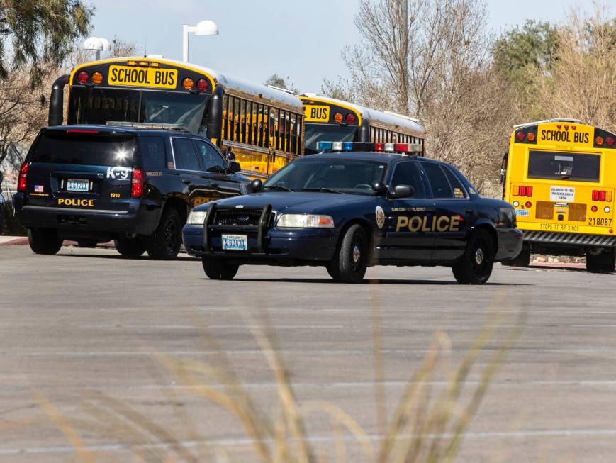 The Clark County School district police vehicles are seen as students at Desert Oasis leave the ...