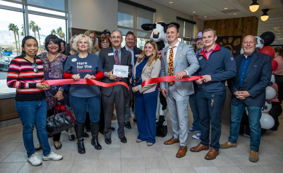 Chick-Fil-A Owner/Operators Misti and Foster Cunningham, center, cut a ribbon with Las Vegas Ch ...