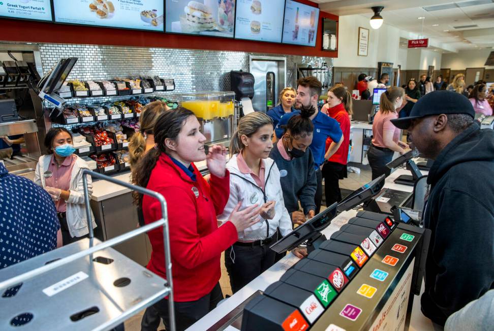 Megan Woodcock, from left, and Aline Gomez take an order for customer Derrick Franklin as the n ...