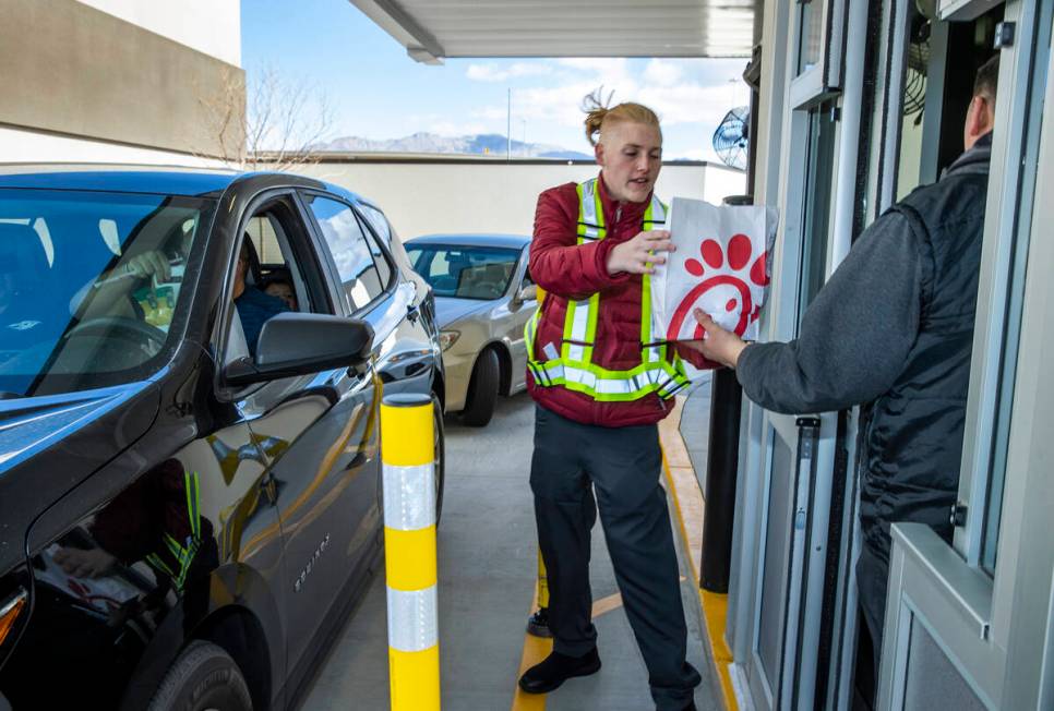 Carson Heese serves a customer as the new Chick-Fil-A opens complete with a ribbon cutting cere ...