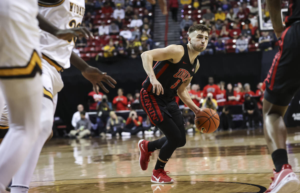 UNLV Rebels guard Jordan McCabe (5) brings the ball up court against the Wyoming Cowboys during ...