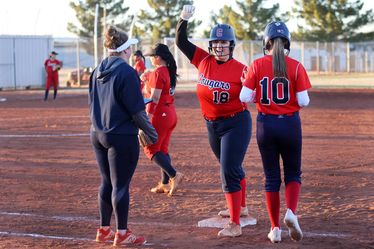 Coronado’s Faith Javate (18), with Charlotte Pietrzak (10), reacts after getting a hit a ...