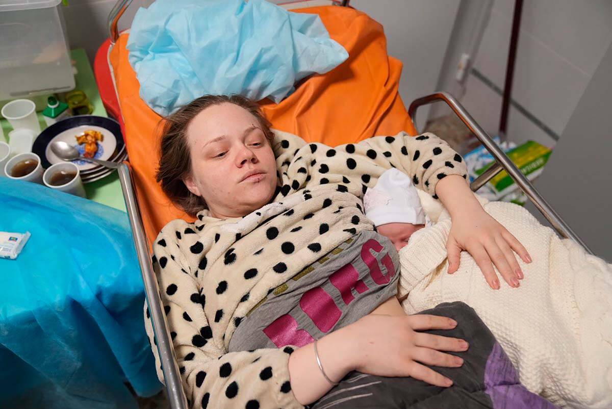 Mariana Vishegirskaya lies in a hospital bed after giving birth to her daughter Veronika, in Ma ...