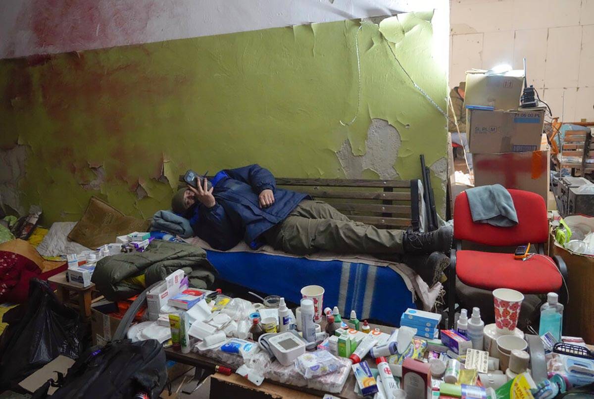 A local citizen rests in a basement for shelter in the center of the town of Irpin, some 25 km ...