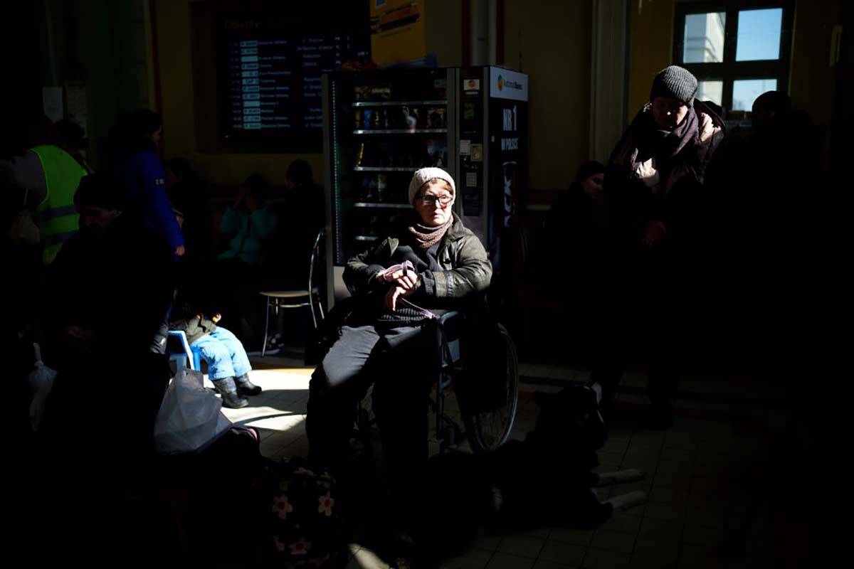 Ukrainian refugees wait at Przemysl train station, southeastern Poland, on Friday, March 11, 20 ...