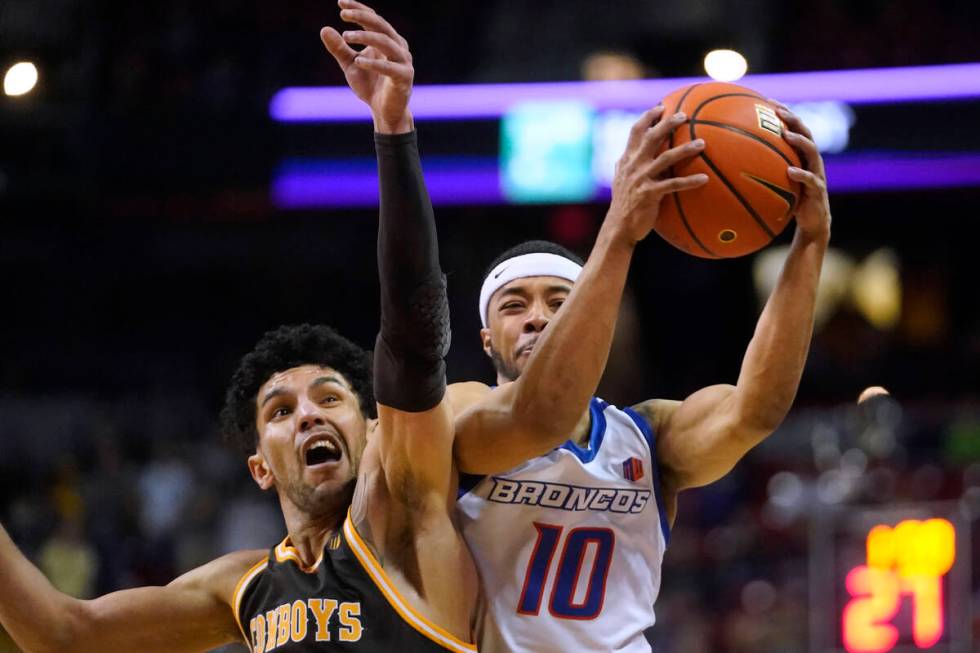 Wyoming guard Hunter Maldonado, left, defends against Boise State guard Marcus Shaver Jr. (10) ...