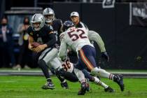 Chicago Bears outside linebacker Khalil Mack (52) chases down Raiders quarterback Derek Carr (4 ...
