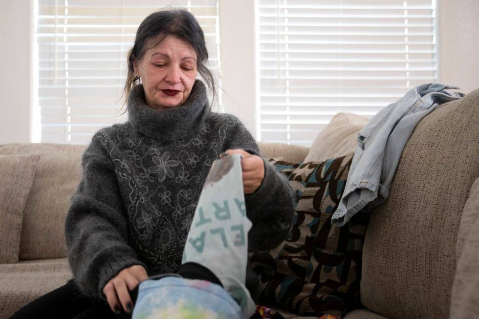 Mihaela Steyer folds the last clothing her late son, Louis Steyer, wore before passing away of ...