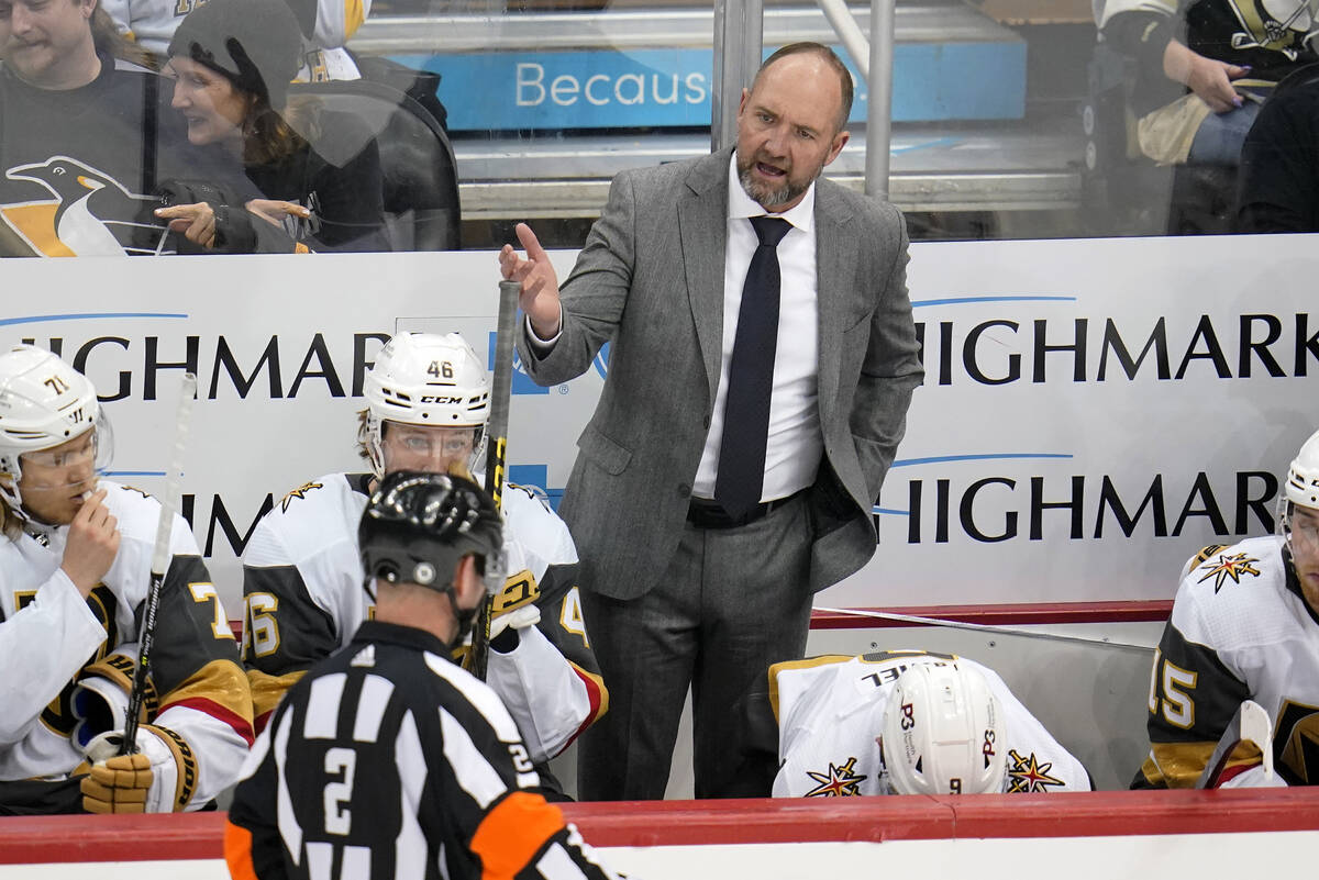 Vegas Golden Knights head coach Peter DeBoer has a word with referee Jon McIsaac (2) during the ...