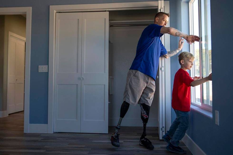 Army Sergeant Adam Poppenhouse, who was injured in Iraq in 2006, and his son A.J. Poppenhouse, ...