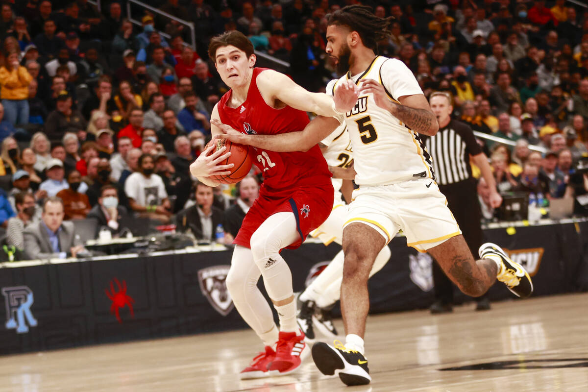 Richmond guard Andre Gustavson (22) drives for the basket as Virginia Commonwealth guard Marcus ...