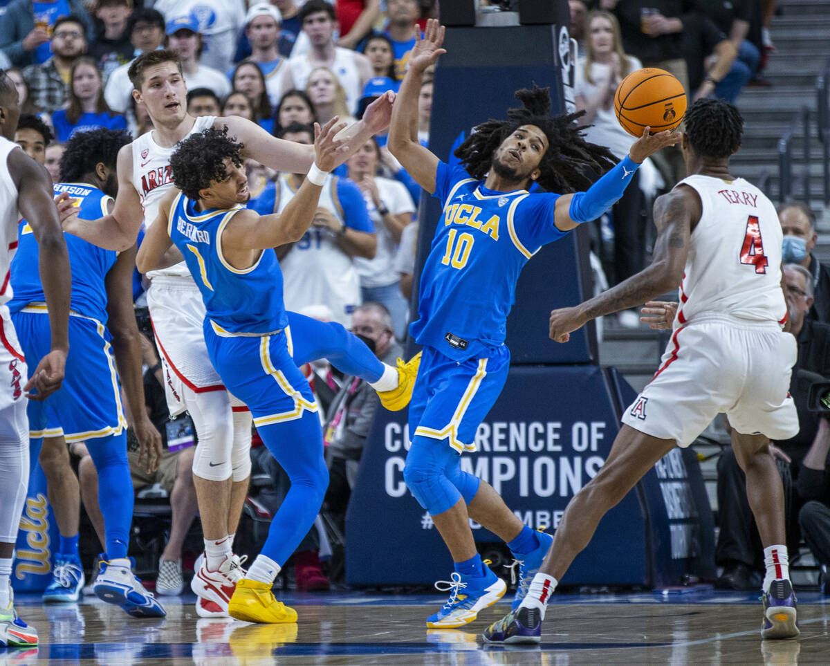 UCLA Bruins guard Tyger Campbell (10) reaches for a rebound beside teammate UCLA Bruins guard J ...