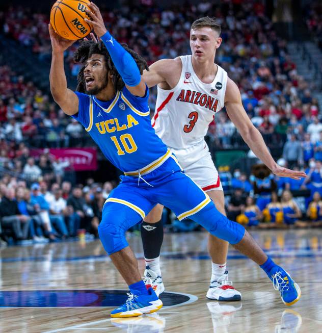 UCLA Bruins guard Tyger Campbell (10) drives the lane past Arizona Wildcats guard Pelle Larsson ...