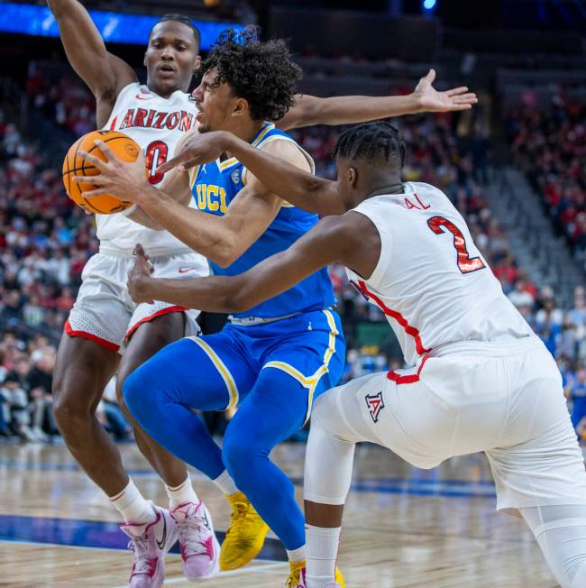 UCLA Bruins guard Jules Bernard (1) is fouled hard by Arizona Wildcats guard Adama Bal (2) with ...