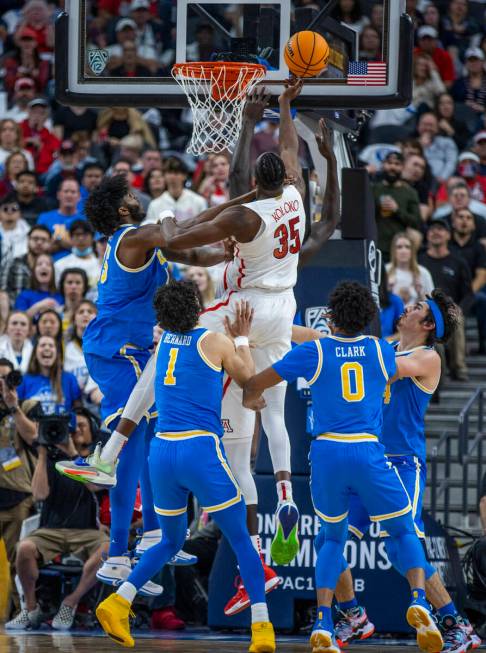 Arizona Wildcats center Christian Koloko (35) gets off a tip shot over UCLA Bruins center Myles ...