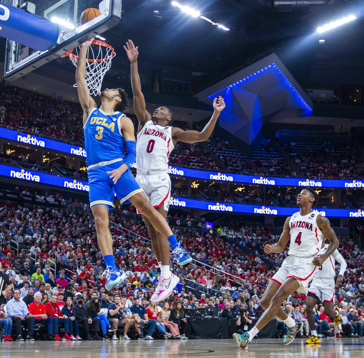 UCLA Bruins guard Johnny Juzang (3) gets inside of Arizona Wildcats guard Bennedict Mathurin (0 ...