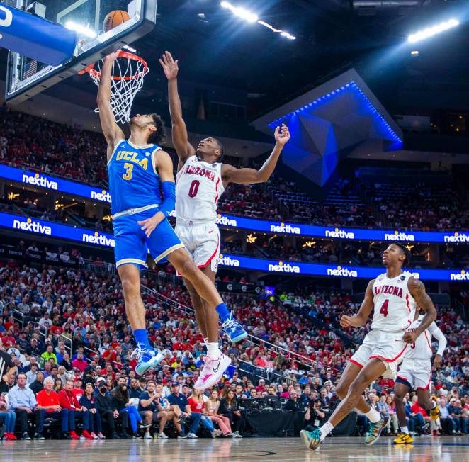 UCLA Bruins guard Johnny Juzang (3) gets inside of Arizona Wildcats guard Bennedict Mathurin (0 ...