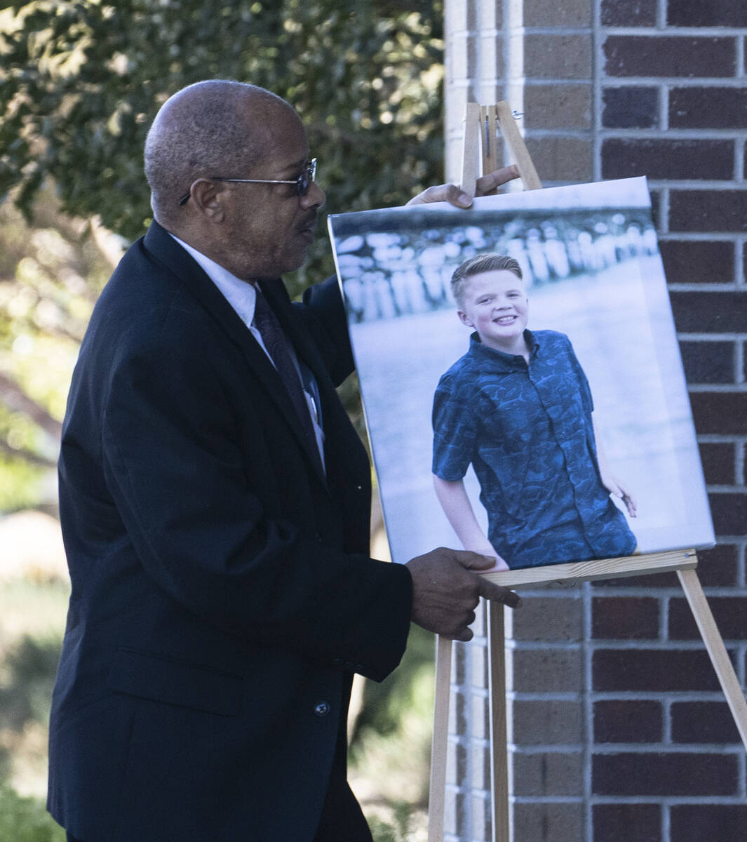 A photograph of Rex Patchett, 13, is carried into Church of Jesus Christ of Latter-day Saints o ...