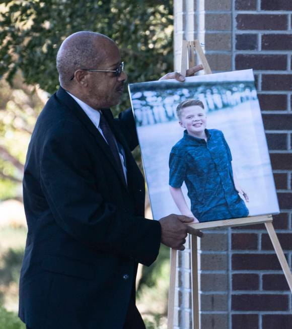 A photograph of Rex Patchett, 13, is carried into Church of Jesus Christ of Latter-day Saints o ...