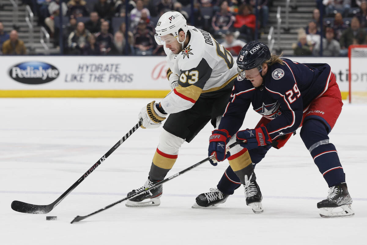 Vegas Golden Knights' Evgenii Dadonov, left, and Columbus Blue Jackets' Patrik Laine chase the ...