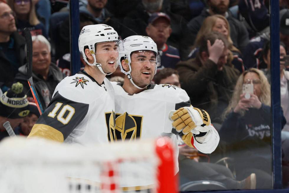 Vegas Golden Knights' Nicolas Roy, left, William Carrier celebrate their goal against the Colum ...