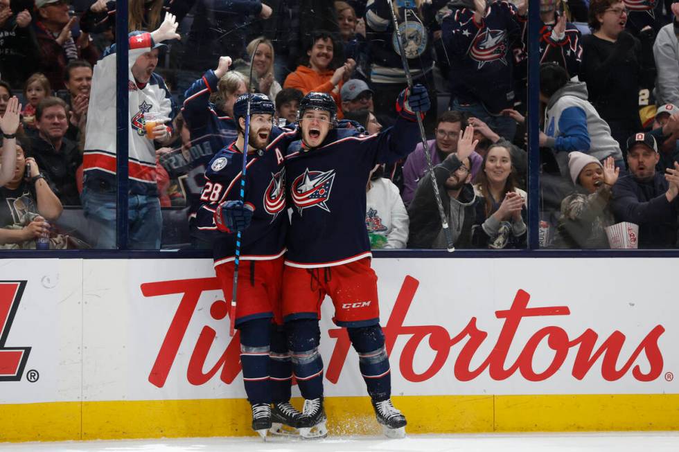 Columbus Blue Jackets' Cole Sillinger, right, celebrates his hat trick against the Vegas Golden ...