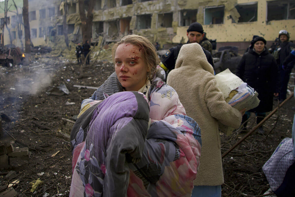 FILE - Mariana Vishegirskaya stands outside a maternity hospital that was damaged by shelling i ...