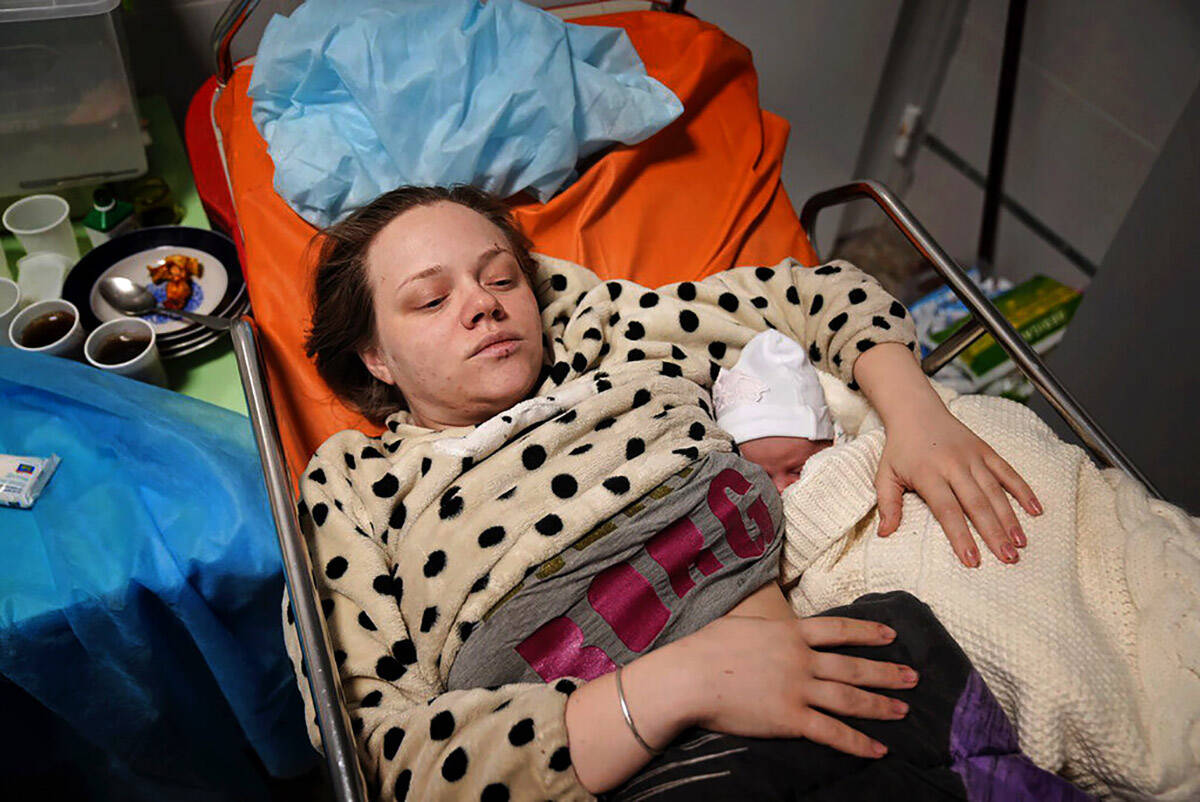 FILE - Mariana Vishegirskaya lies in a hospital bed after giving birth to her daughter Veronika ...