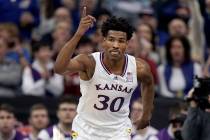 Kansas guard Ochai Agbaji (30) celebrates after making a basket during the first half of an NCA ...