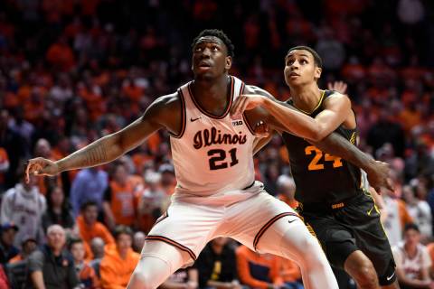 Illinois' Kofi Cockburn (21) boxes out Iowa's Kris Murray during the second half of an NCAA col ...