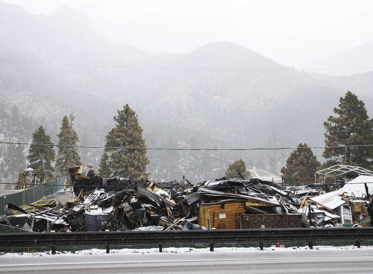 Debris of the former Mount Charleston Lodge is seen as light snow falls on the Mount Charleston ...