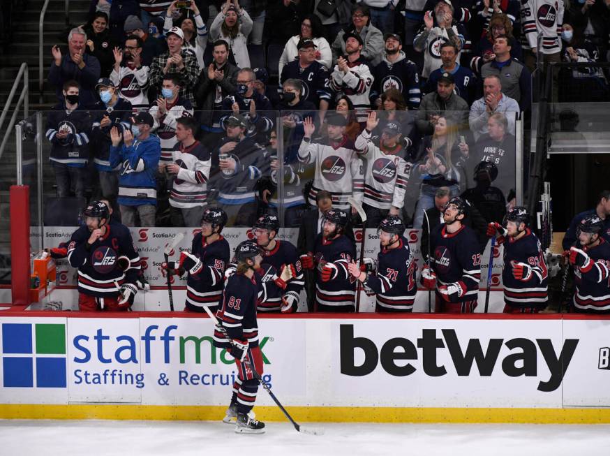 Winnipeg Jets' Kyle Connor (81) is congratulated by teammates for his goal against the Vegas Go ...