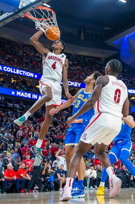 Arizona Wildcats guard Dalen Terry (4) dunks the ball over UCLA Bruins guard Johnny Juzang (3) ...