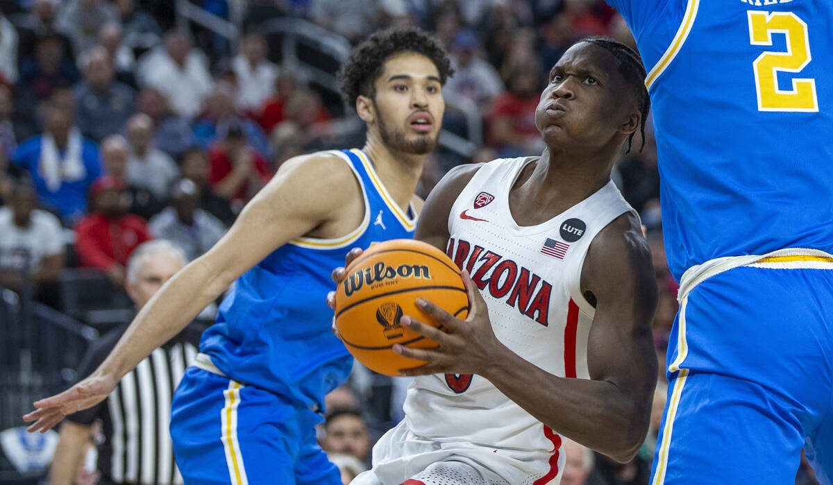 Arizona Wildcats guard Bennedict Mathurin (0) gets past UCLA Bruins guard Johnny Juzang (3) and ...