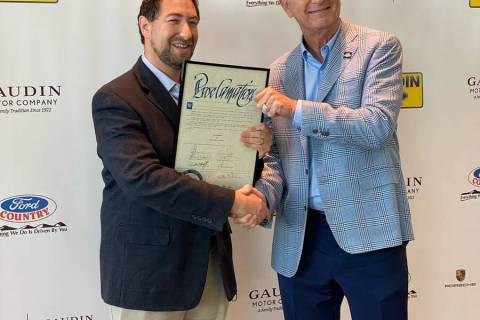 Gaudin Motor Co. owner Gary Ackerman, right, receives a proclamation from Clark County Commissi ...