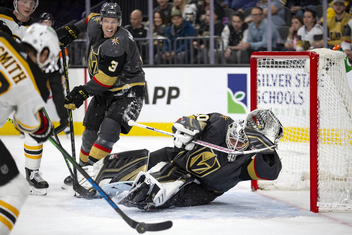 Golden Knights goaltender Robin Lehner (90) dives to save a shot by Bruins center Craig Smith ( ...