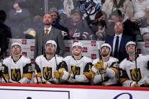 Vegas Golden Knights coach Pete DeBoer, left, and players look up to view a replay of a Winnipe ...